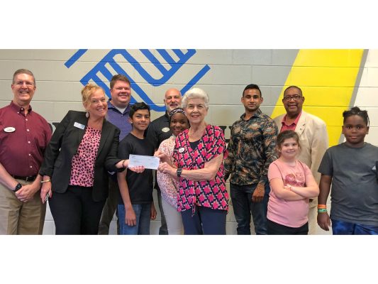 Youth from the Boys & Girls Club of Marion County join Herb Silverman, April Savarese, Clinton Slier, Troy Weaver, Phyllis Silverman, Karan Gaekwad and Herman Brown for the check presentation