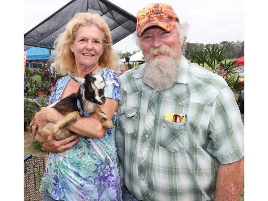 Jon and Cindy Johnson with a Nigerian dwarf goat