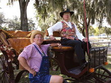 Kathy Smith, standing, and Barbara Turcyn dress the parts as Victorian-style carriage drivers.