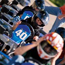Office Manager Kellie Moore (#40) adjusts her go kart prior to the first race.