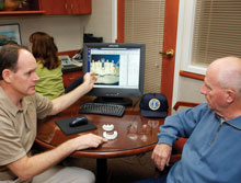 Dr. Farrell (left) takes the time to carefully explain the scan results to his patients.
