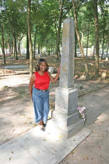 Narvella Haynes next to one of the graves of Chestnut Cemetery, a clean-up project she’s spearheaded. Most of Narvella’s days begin at 5am.