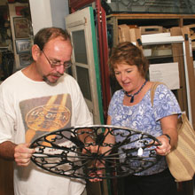 Bob Treen of Old South Antiques in Eustis tells Mary Ann DeSantis about a wrought iron decor item.